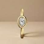 Gold wristwatch with white dial on a beige background