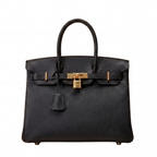 Black handbag with gold hardware on a white background