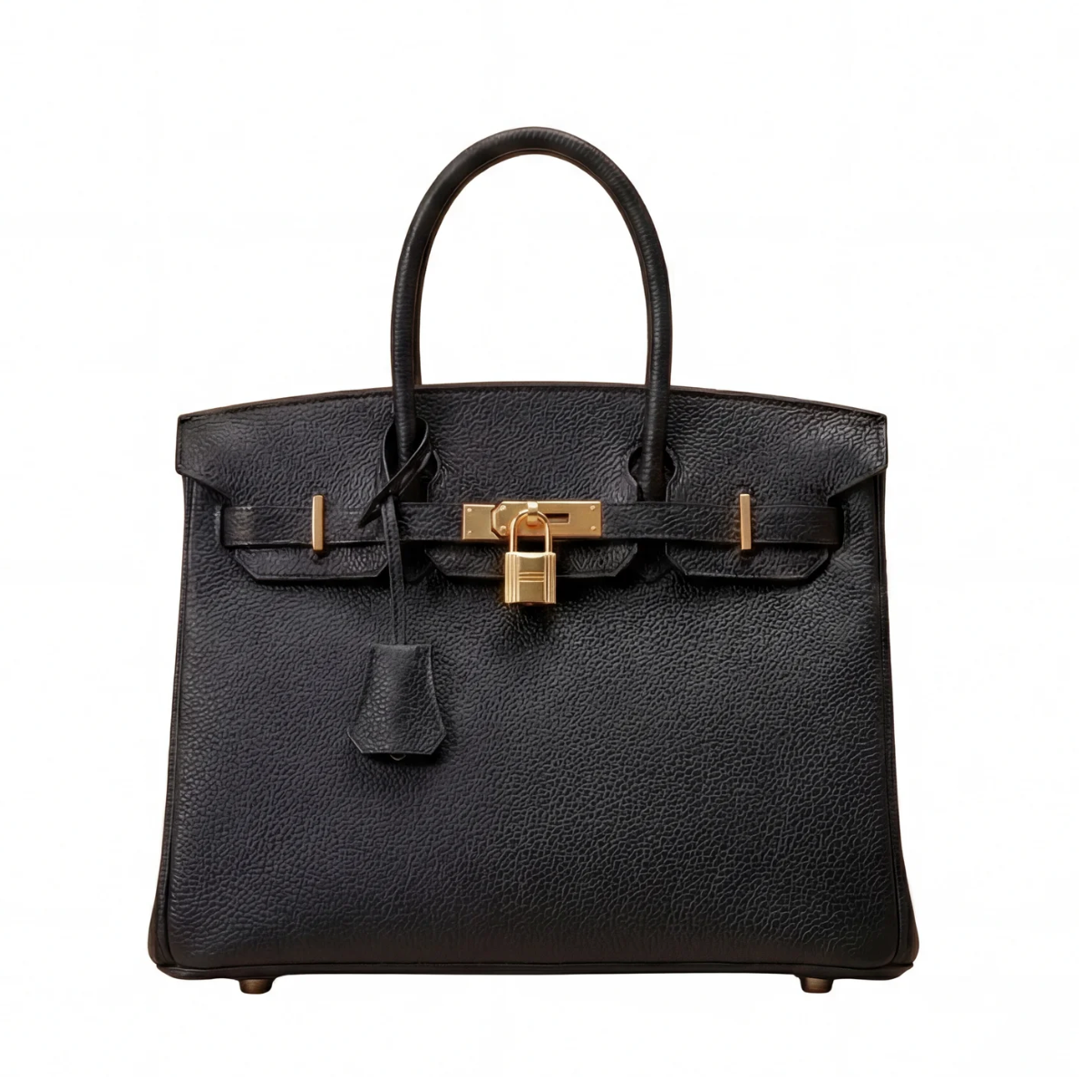 Black handbag with gold hardware on a white background