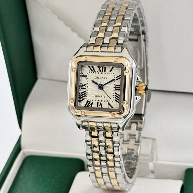 Two-tone watch with a gold and silver band on a white background